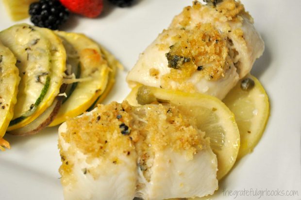 Close up of dover sole rollatini with vegetables on plate.