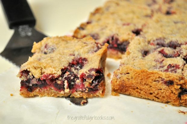 Blackberry pie bar close up photo, resting on a serving spatula