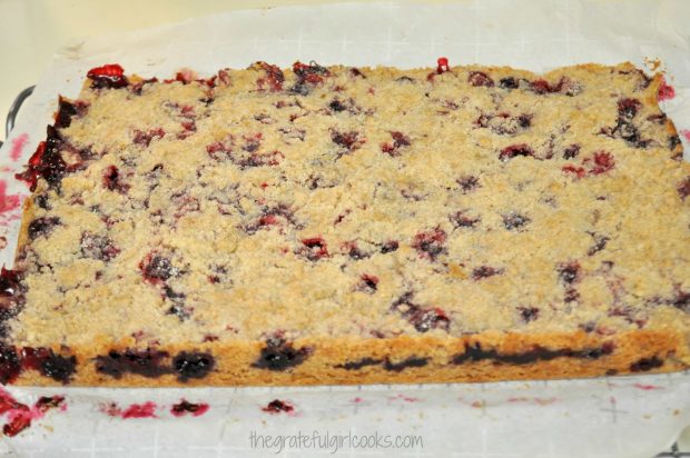 Blackberry pie bars are removed from pan after baking