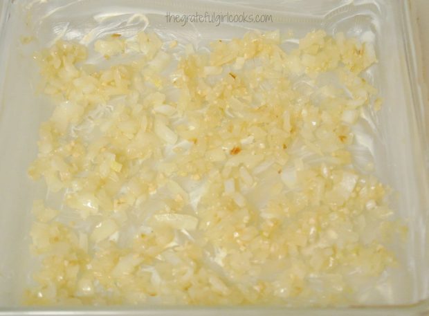 Cooked onions and garlic are added to baking dish