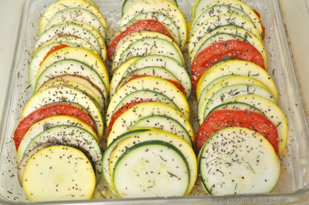 Layered summer vegetables for tian are placed into baking dish.