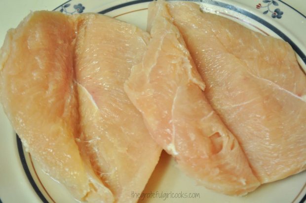 Boneless chicken breasts are cut almost all the way through, forming a pocket.