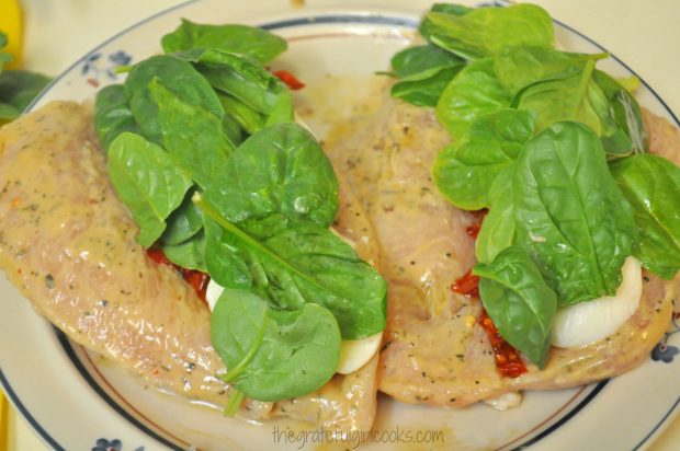 Baby spinach leaves are added to the stuffed chicken breasts.