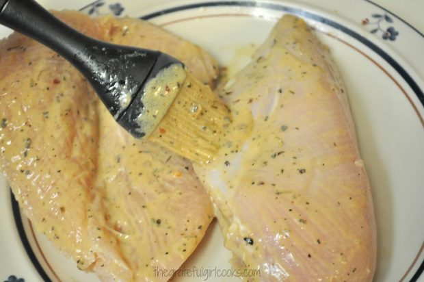 Sauce is brushed onto all sides of the chicken breasts.