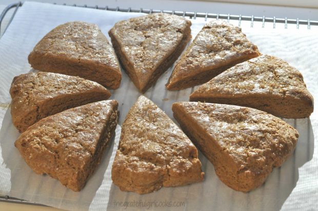 Baked gingerbread scones cooling on a wire rack after baking.