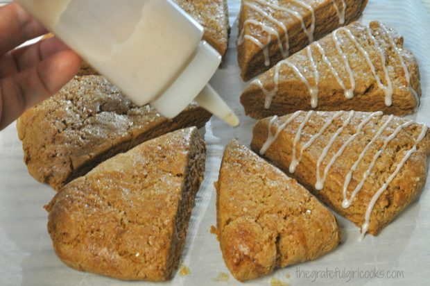 Gingerbread scones are decorated with a vanilla glaze on top.