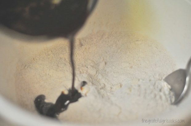 Molasses mixture is poured into dry ingredients for gingerbread scone batter.