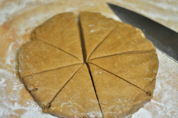 Gingerbread scones dough is cut into 8 wedges before baking.