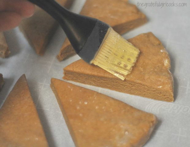 Egg whites are brushed onto tops of gingerbread scones before baking.