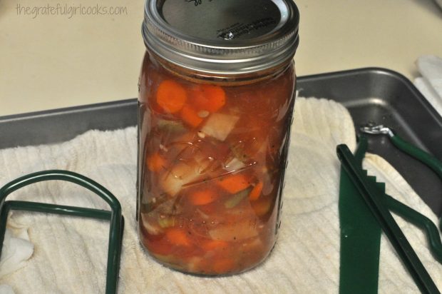 Beef stew is ladled into canning jars, then sealed before canning.
