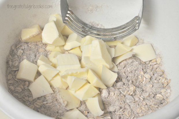 Butter is cut into streusel topping for old-fashioned crisp.