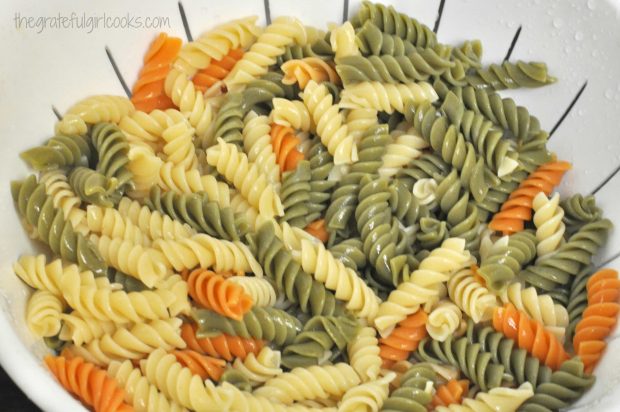 Colorful rainbow rotini pasta is used for the pasta salad.