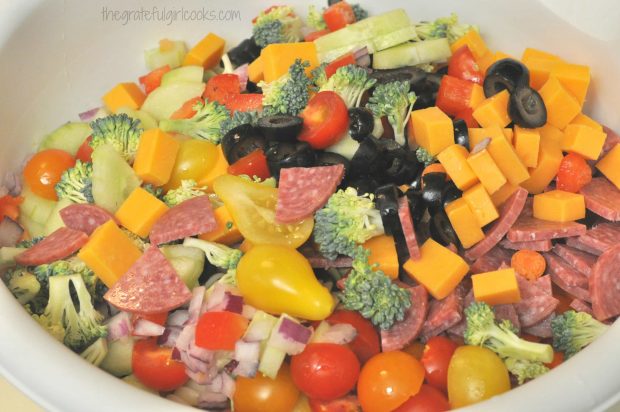 All the veggies and cooked pasta are placed in a large bowl.