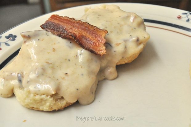 Southern Buttermilk Biscuits with bacon gravy on top, on plate