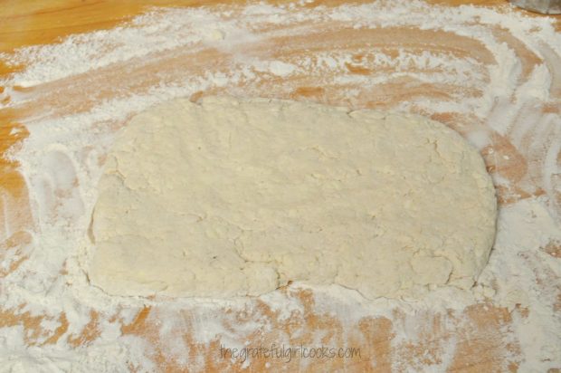 Southern biscuit dough rolled out on floured surface