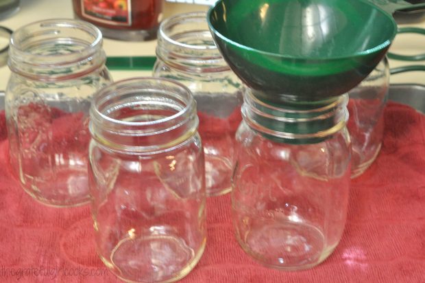 Canning jars and funnel are ready to fill with split pea and ham soup before processing.