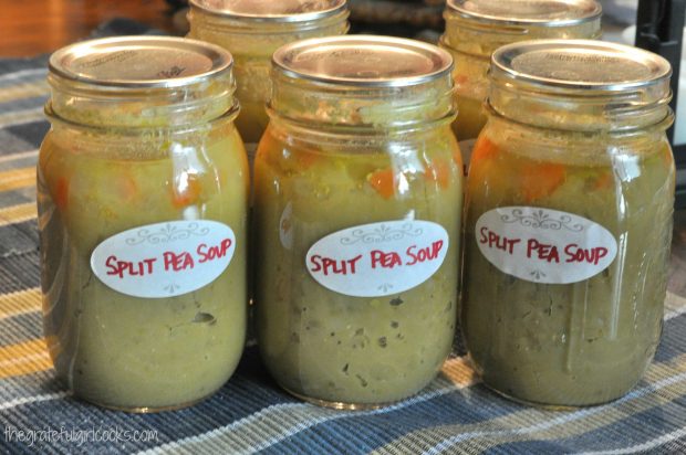 Jars of canned split pea and ham soup are cooled, labeled and stored.