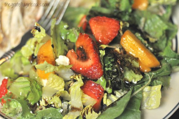 This fruit medley green salad is drizzled with an olive oil/balsamic dressing.