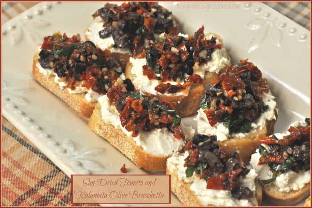 This delicious sun dried tomato kalamata olive bruschetta appetizer features toasted garlic crostini with feta, cream cheese, and fresh basil!