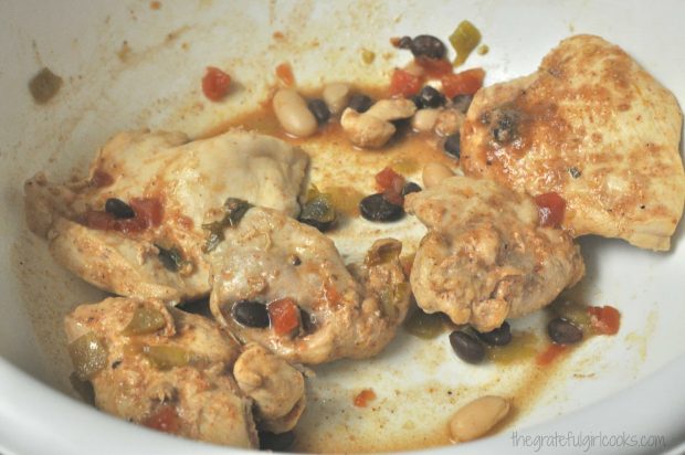 The chicken is removed from the crockpot after cooking, and is then shredded.