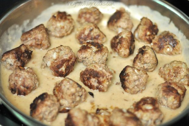 Mom's Swedish meatballs are added back into gravy in skillet.