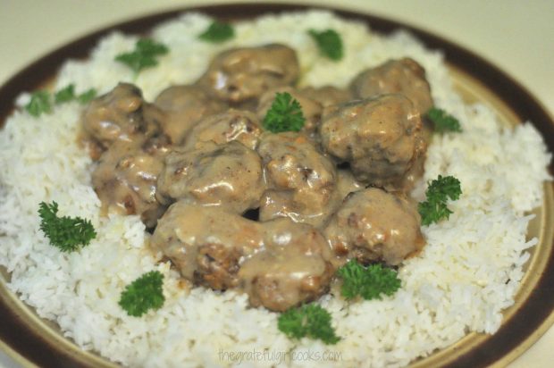 Mom's Swedish Meatballs with gravy are served on top of a bed of rice.