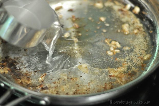 Hot water is added to Swedish meatball drippings in skillet to begin making gravy.