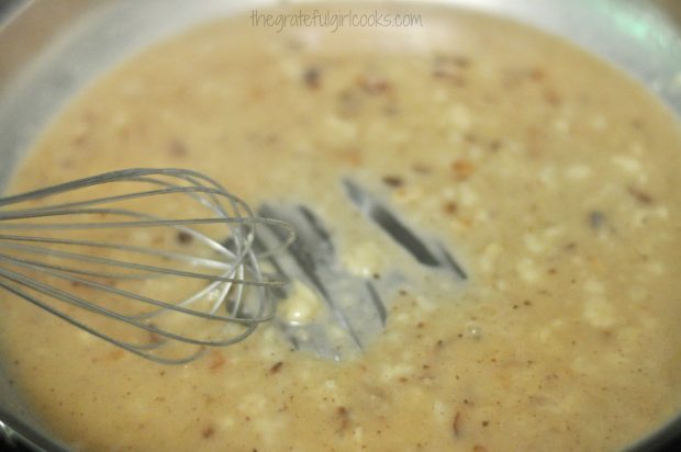 Whisking ingredients for Swedish meatballs gravy in skillet.