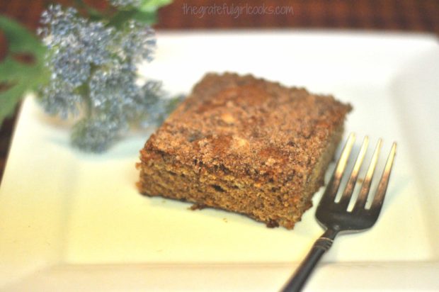 One piece of the old-fashioned crumb coffeecake, on a white plate.