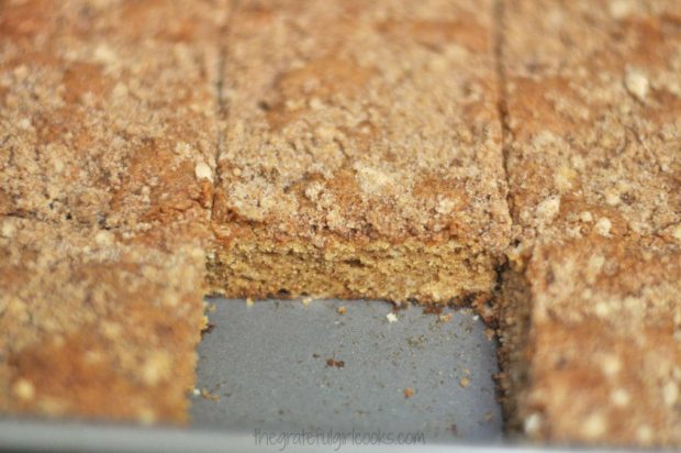 Crumb coffeecake has baked, and been cut into pieces to eat.