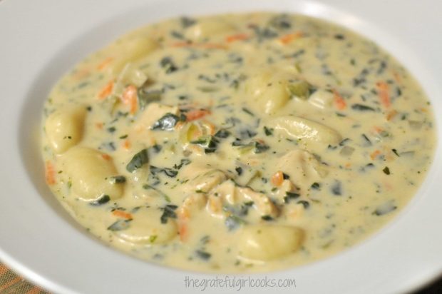 Thick, creamy gnocchi soup in white bowl