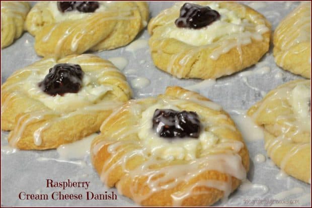 Raspberry cream cheese danish are crescent roll pastries with sweet cream cheese filling, baked and topped with jam, and drizzled with a simple glaze.