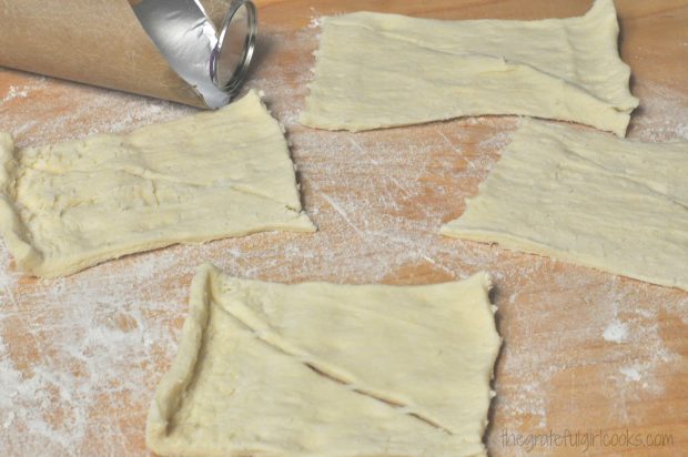 Canned crescent roll dough is rolled out into rectangles.