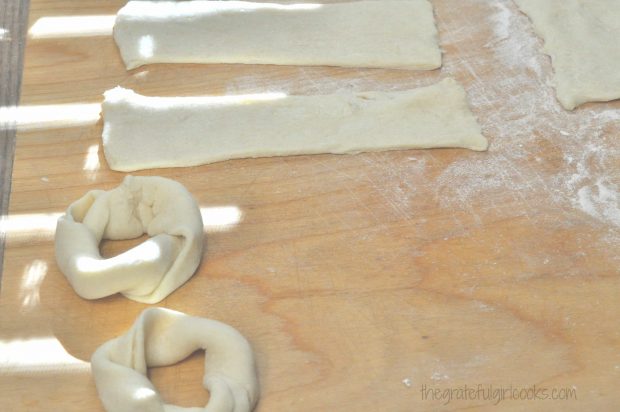 The crescent roll dough is shaped into round rings.