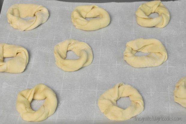 Dough circles are placed onto parchment paper line baking sheet.