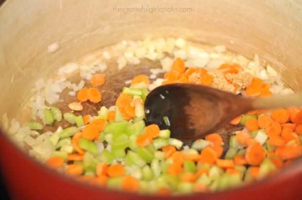 Diced carrots, celery and garlic are cooked with onions for soup
