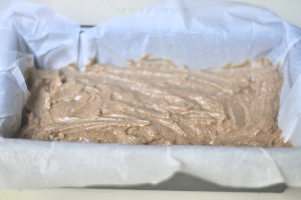 Batter for Starbucks gingerbread (copycat recipe) is placed in paper lined bread pan to bake.