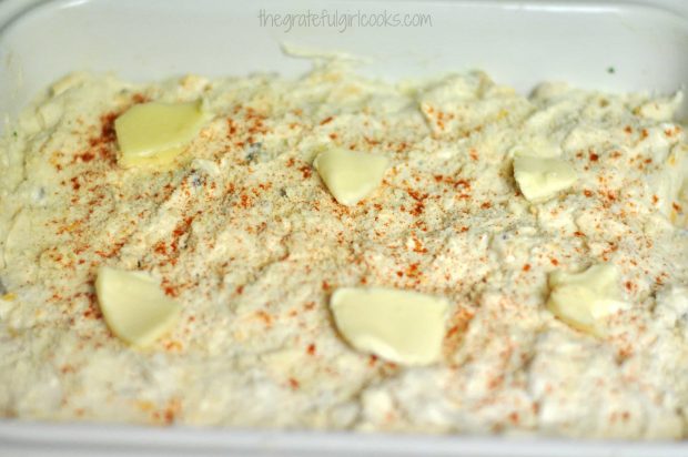 Pads of butter placed on top of casserole before baking