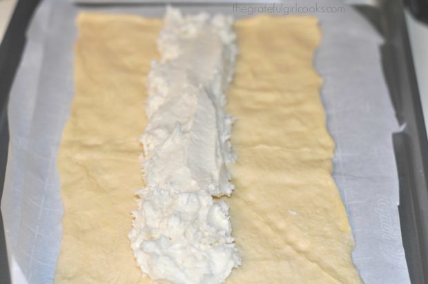 Cream cheese filling for chocolate cream cheese danish, is placed on crescent dough.