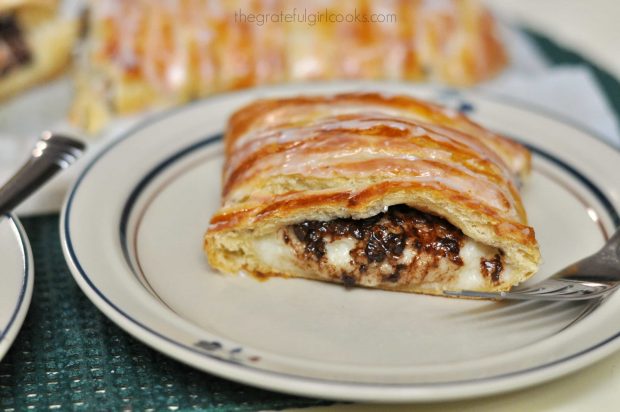 Slice of chocolate cream cheese danish on a plate with fork