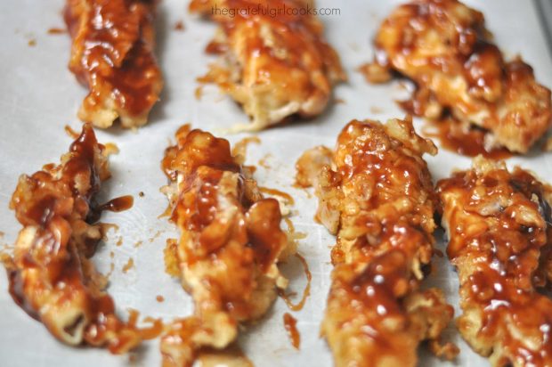 Browned honey bbq chicken strips ready to bake in the oven.