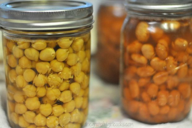 Garbanzo beans and pinto beans are canned and ready to store in pantry.