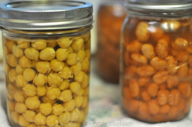 Garbanzo beans and pinto beans are canned and ready to store in pantry.