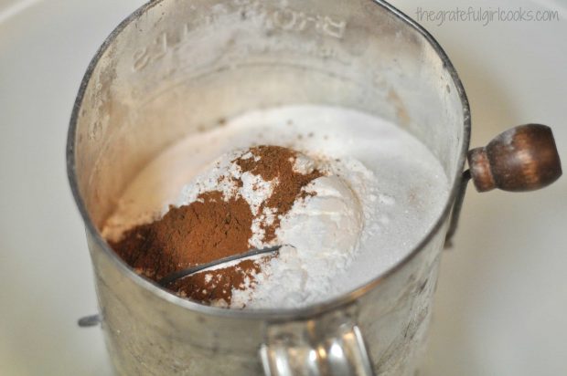 Dry ingredients for doughnuts are sifted together.
