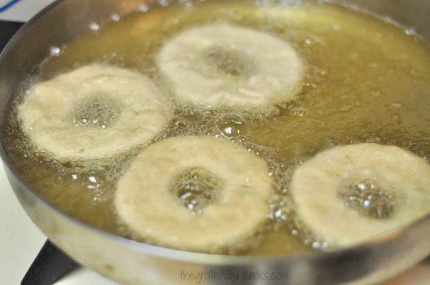 The doughnuts are cooked in very hot oil to brown.