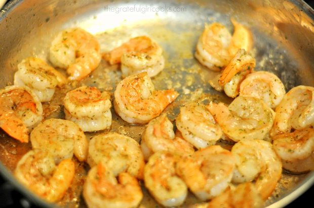 Shrimp is pan-seared in skillet for Shrimp Penne Pasta Alfredo.