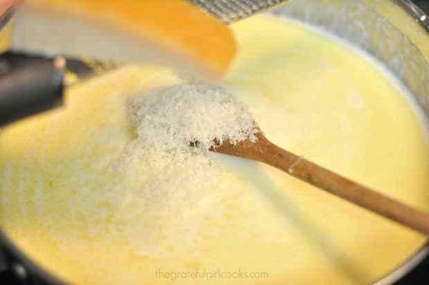 Grated, fresh Parmesan cheese is added to sauce for Shrimp Penne Pasta Alfredo.