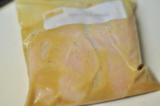 Chicken marinating in plastic bag
