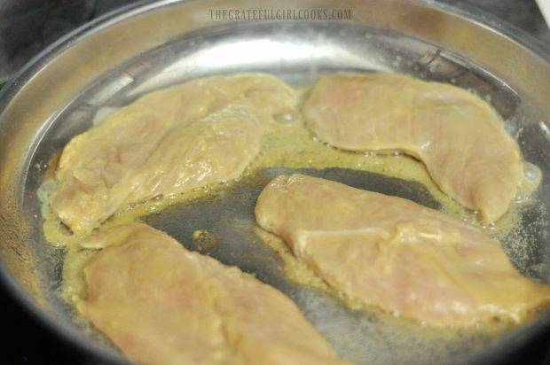 Chicken breasts cooking in skillet