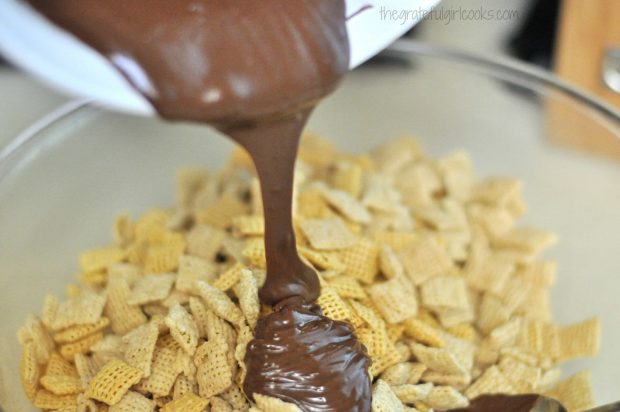 Chocolate Peanut Butter Muddy Buddies sauce is poured over crispy cereal.